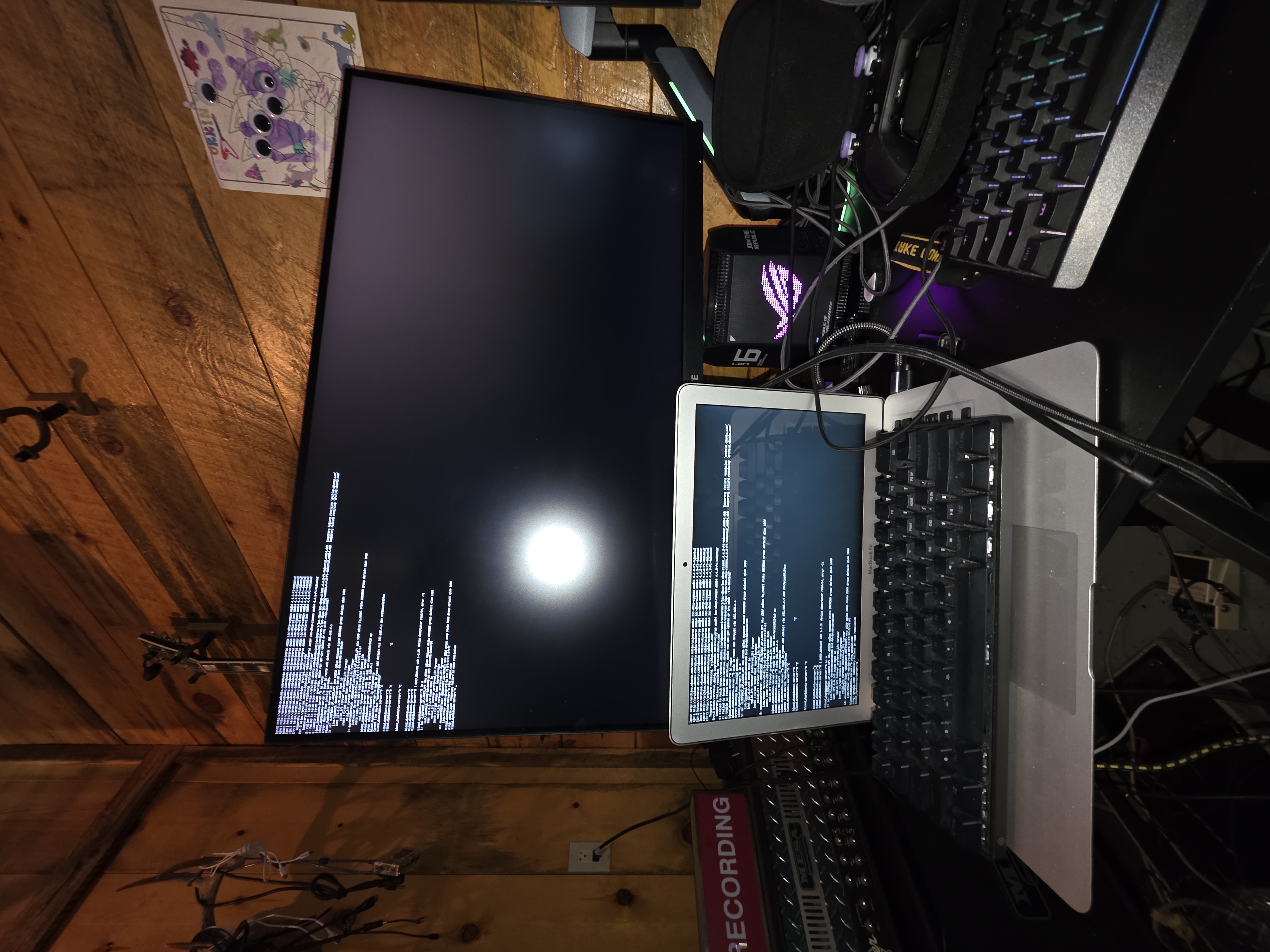 Terminal sessions running on MacBook with large display overhead in the pine cabin